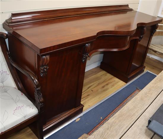 An early Victorian mahogany serpentine sideboard W.210cm